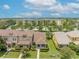 Aerial view showcasing the townhome's landscaping and proximity to nearby apartments and parking at 13636 Beauregard Pl, Orlando, FL 32837