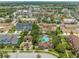 Beautiful aerial view showcases a community pool, clubhouse, and recreation area surrounded by lush landscaping at 13636 Beauregard Pl, Orlando, FL 32837