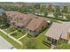 Aerial view of townhomes with meticulously maintained lawns and landscaping in a desirable neighborhood at 13636 Beauregard Pl, Orlando, FL 32837