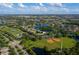 Breathtaking aerial view featuring neighborhood amenities, including a lake, sports fields, and recreational spaces at 13636 Beauregard Pl, Orlando, FL 32837