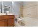Bathroom with wood vanity, toilet, and tiled shower-tub combination at 13636 Beauregard Pl, Orlando, FL 32837