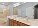 Bathroom featuring a double vanity, a large mirror, and a tiled shower and tub at 13636 Beauregard Pl, Orlando, FL 32837