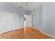 Bedroom featuring laminate wood flooring, closet, and access to kitchen at 13636 Beauregard Pl, Orlando, FL 32837