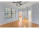 Large bedroom featuring a window, a ceiling fan, and multiple doors at 13636 Beauregard Pl, Orlando, FL 32837