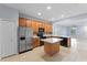 Modern kitchen featuring a stainless steel refrigerator, black appliances, and a tiled backsplash at 13636 Beauregard Pl, Orlando, FL 32837