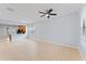 Bright living room featuring tiled flooring, neutral walls, and seamless access to the kitchen area at 13636 Beauregard Pl, Orlando, FL 32837