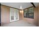 Outdoor patio featuring tiled flooring, white french doors and window at 13636 Beauregard Pl, Orlando, FL 32837