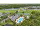 Aerial view of community amenities, including a pool, clubhouse, and tennis courts at 14167 Bradbury Rd, Orlando, FL 32828