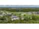Expansive aerial view showcasing a community pool, clubhouse, tennis courts, ponds and green spaces at 14167 Bradbury Rd, Orlando, FL 32828