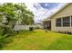 Landscaped backyard features green grass, mature trees, and a privacy fence at 14167 Bradbury Rd, Orlando, FL 32828