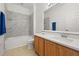Bathroom with a marble tiled shower, wood vanity and quartz countertop at 14167 Bradbury Rd, Orlando, FL 32828