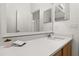 Well-lit bathroom features a granite countertop, framed mirror, and modern sink at 14167 Bradbury Rd, Orlando, FL 32828