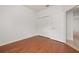 Guest bedroom with wood floors, closet, and a view into the hallway at 14167 Bradbury Rd, Orlando, FL 32828