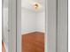 View of the bedroom through a doorway, showing wood floors and natural light at 14167 Bradbury Rd, Orlando, FL 32828