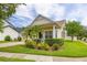 Charming home with manicured lawn, lush landscaping, and a welcoming front porch at 14167 Bradbury Rd, Orlando, FL 32828