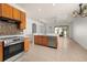 Modern kitchen with stainless steel appliances, tile flooring, and center island at 14167 Bradbury Rd, Orlando, FL 32828