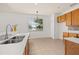 Eat-in kitchen features a large window, stainless steel sink and faucet, and ample cabinet space at 14167 Bradbury Rd, Orlando, FL 32828
