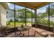 A screened-in lanai offers a comfortable outdoor seating area with a view of the backyard at 14167 Bradbury Rd, Orlando, FL 32828
