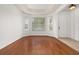 Spacious living room featuring hardwood floors, tray ceiling, and natural light at 14167 Bradbury Rd, Orlando, FL 32828
