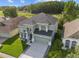 Aerial view of a two-story home with a manicured lawn in a suburban neighborhood at 14412 Saint Georges Hill Dr, Orlando, FL 32828
