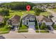 Aerial view of a suburban home featuring a well-manicured lawn, set among green spaces at 14412 Saint Georges Hill Dr, Orlando, FL 32828