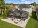 Aerial view of the home with screened-in pool, spa, and patio at 14412 Saint Georges Hill Dr, Orlando, FL 32828