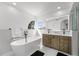 Elegant bathroom with a freestanding tub, dual vanities, and a large window offering natural light at 14412 Saint Georges Hill Dr, Orlando, FL 32828