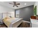 Bright bedroom featuring a wooden bed frame, ceiling fan, and neutral wall colors at 14412 Saint Georges Hill Dr, Orlando, FL 32828