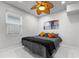 Cozy bedroom with neutral colors, ceiling fan, and natural light at 14412 Saint Georges Hill Dr, Orlando, FL 32828