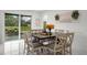 Dining area with modern table, chairs, view of the pool, and access to the backyard at 14412 Saint Georges Hill Dr, Orlando, FL 32828