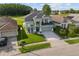 Two-story home boasting a manicured lawn and a two-car garage in a suburban setting at 14412 Saint Georges Hill Dr, Orlando, FL 32828