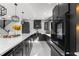 Spacious kitchen with black cabinets, stainless steel appliances, quartz countertops, and pendant lighting at 14412 Saint Georges Hill Dr, Orlando, FL 32828