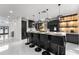 Modern kitchen featuring black cabinets, a central island with seating, and unique pendant lighting at 14412 Saint Georges Hill Dr, Orlando, FL 32828