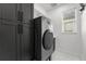 Modern laundry room featuring new washer/dryer, built in cabinets, and natural light at 14412 Saint Georges Hill Dr, Orlando, FL 32828