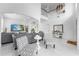 Open-concept living room with a two-story ceiling, marble floors, and modern furnishings at 14412 Saint Georges Hill Dr, Orlando, FL 32828