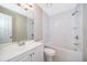 Bright bathroom with white tile, soaking tub, updated vanity and sink with contemporary lighting at 1614 Shady Ridge Ct # 252, Orlando, FL 32807