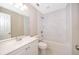 Bright bathroom with white tile, soaking tub, updated vanity and sink with contemporary lighting at 1614 Shady Ridge Ct # 252, Orlando, FL 32807