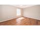 Neutral bedroom with window and ceiling fan providing natural light, and wood flooring at 1614 Shady Ridge Ct # 252, Orlando, FL 32807