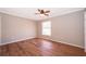 Empty bedroom with wood laminate flooring, a ceiling fan, and neutral paint at 1614 Shady Ridge Ct # 252, Orlando, FL 32807
