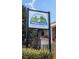 The Hidden Creek townhome condominium sign with lush landscaping and clear skies at 1614 Shady Ridge Ct # 252, Orlando, FL 32807