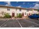 Townhouse featuring a stucco facade, red trim, and reserved parking spaces at 1614 Shady Ridge Ct # 252, Orlando, FL 32807