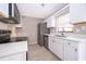 Modern kitchen features stainless steel appliances, white cabinets, and light countertops at 1614 Shady Ridge Ct # 252, Orlando, FL 32807