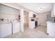 Updated kitchen with stainless steel appliances and an attached laundry area at 1614 Shady Ridge Ct # 252, Orlando, FL 32807