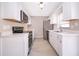 Updated kitchen with stainless steel appliances, white cabinets and tile flooring at 1614 Shady Ridge Ct # 252, Orlando, FL 32807