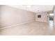 Open-concept living room with ceiling fan, light-colored tile flooring, and natural light at 1614 Shady Ridge Ct # 252, Orlando, FL 32807