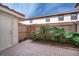Outdoor patio featuring brick pavers, a wooden fence, and lush greenery at 1614 Shady Ridge Ct # 252, Orlando, FL 32807
