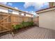 Outdoor patio featuring brick pavers, a wooden fence, and lush greenery at 1614 Shady Ridge Ct # 252, Orlando, FL 32807