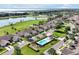 Aerial view showcases community with pool, lake, and golf course offering scenic recreational opportunities at 168 Club Villas Ln, Kissimmee, FL 34744