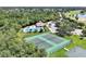 Aerial view showcasing tennis courts, pool, and clubhouse enhancing the community's recreational appeal at 168 Club Villas Ln, Kissimmee, FL 34744