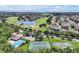 Aerial view features golf course, lake, tennis court, and pool, highlighting community recreation at 168 Club Villas Ln, Kissimmee, FL 34744